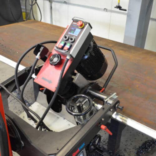 industrial metal beveling machine mounted on a steel plate