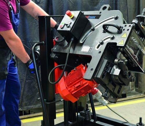 worker operating an industrial metal cutting machine